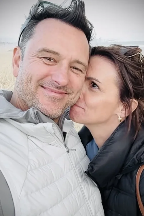 Amy kissing Karl on the cheek in a candid photograph