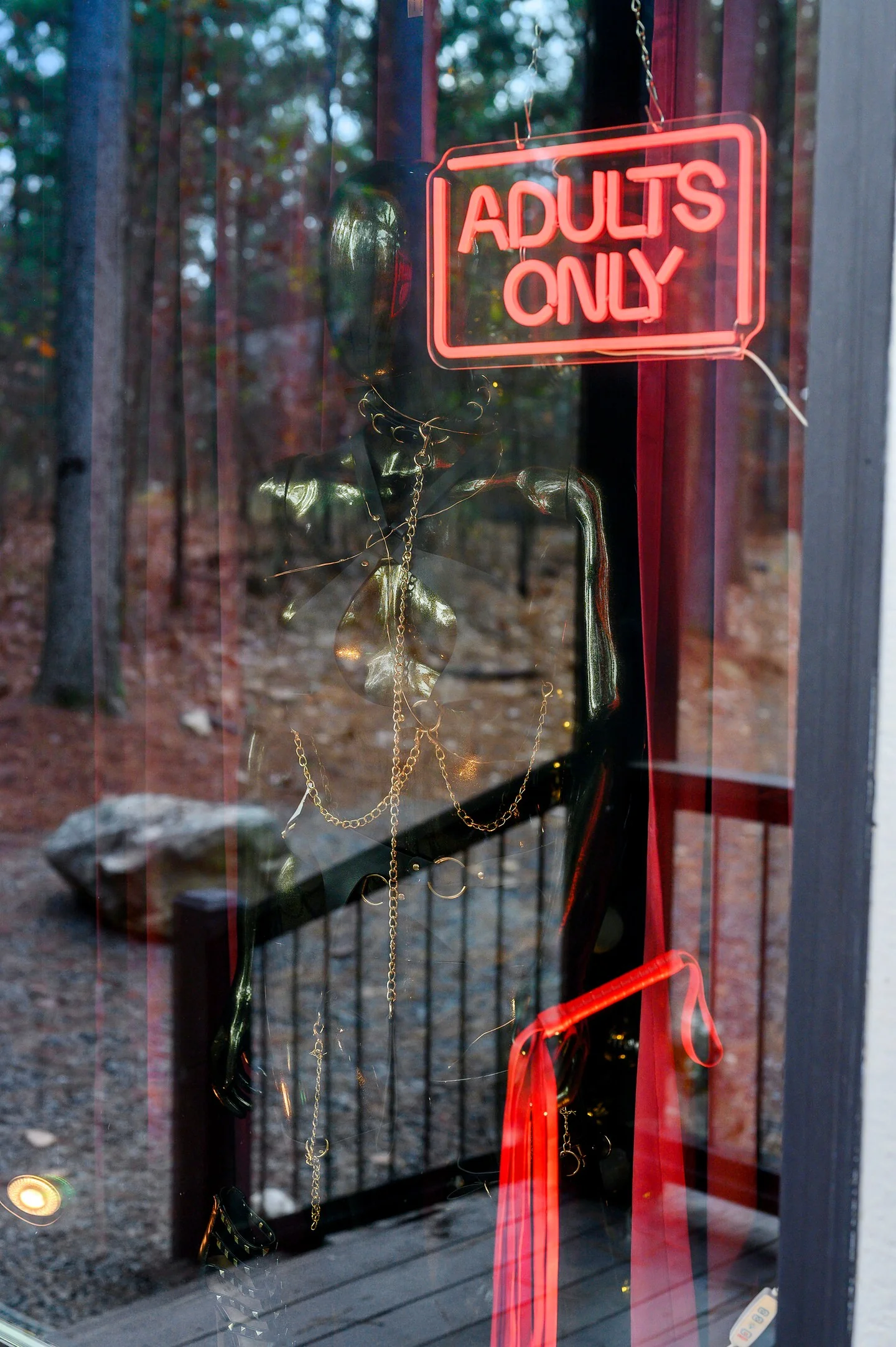 Red Adults Only neon sign in the window at Whisper in the Woods